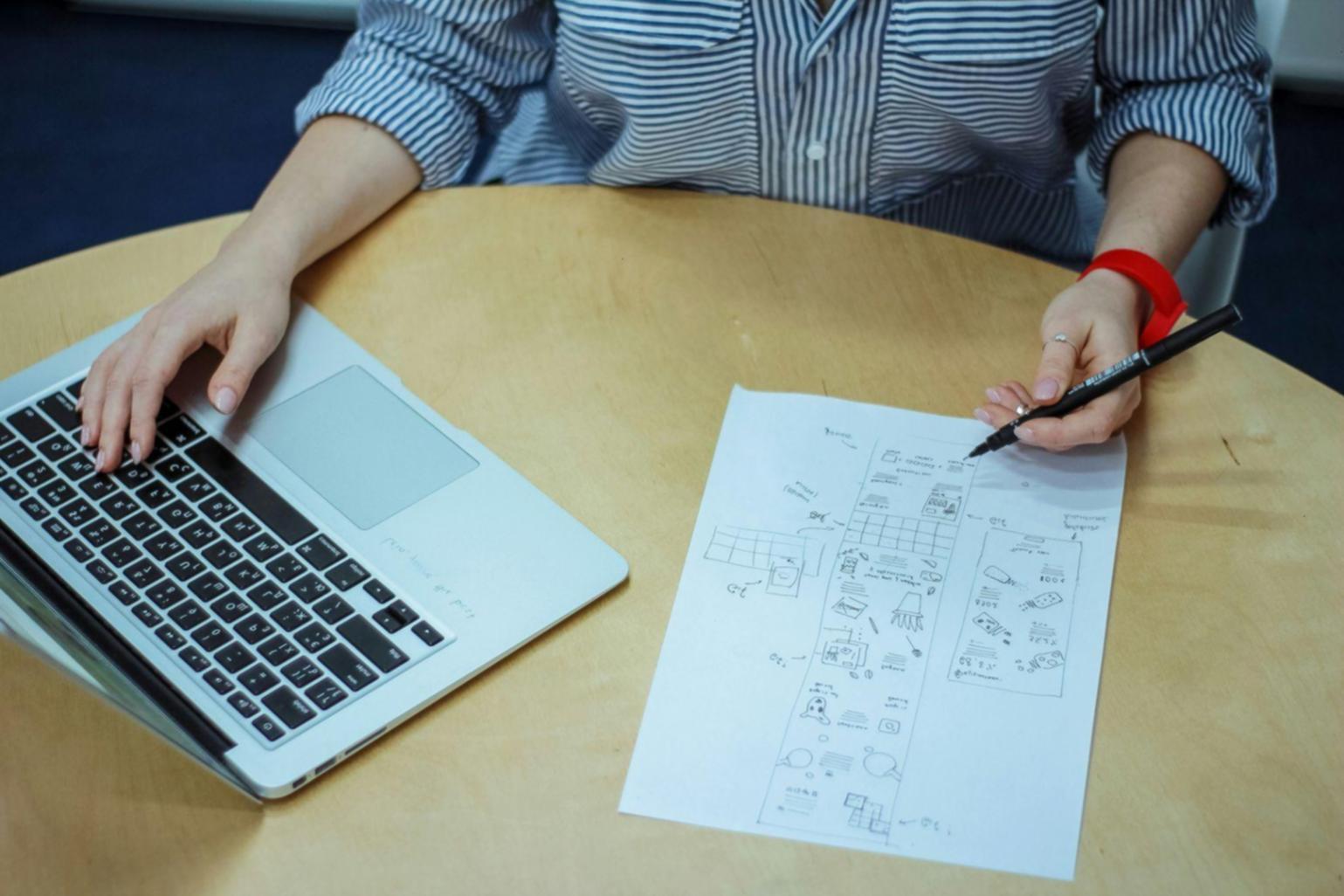 Participant working through budgeting exercises on laptop with calculator